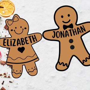 Peut inclure: Deux biscuits en forme de bonhomme en pain d'&eacute;pices, l'un avec le nom "Elizabeth" et l'autre avec le nom "Jonathan".
