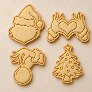 May include: Four light brown cookie cutters with embossed designs. One features a character wearing a Santa hat, one shows two hands forming a heart shape, one depicts a hand holding a round ornament, and one is a Christmas tree with circular details.