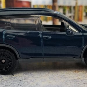 May include: A dark blue SUV toy car with black wheels. The miniature vehicle has a sleek design, featuring a detailed front grille, side mirrors, and tinted windows. The car is a compact model, suitable for display or play.