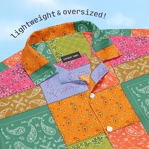 May include: A colorful, patchwork button-down shirt with a paisley pattern in shades of orange, green, pink, and purple. The shirt has a collar and two white buttons. The text "Lightweight & oversized!" is visible.
