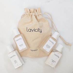 May include: A beige drawstring bag with the word "Lavicity" printed on it, surrounded by four small, clear bottles of toiletries. The bottles are labeled "Shampoo", "Body Lotion", "Hand and Body Wash", and "Conditioner".