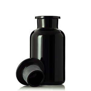 May include: A black glass bottle with a black lid. The lid is off and sitting next to the bottle.