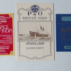 May include: A yellow and red press show ticket for the movie "A Passage to India" with the date March 18th, 1985. A white and gold invitation for a "Passage to India" supper party hosted by P&O and British India Steam Navigation Companies. A blue British Indian passport with the date March 18th, 1965.
