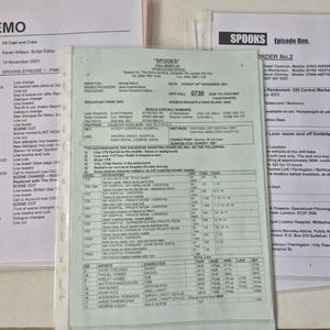 May include: Three printed production documents for the television show Spooks, including a memo dated November 14, 2001, a call sheet for Sunday, November 18, 2001, and a production order, all contained within clear plastic protective sleeves.