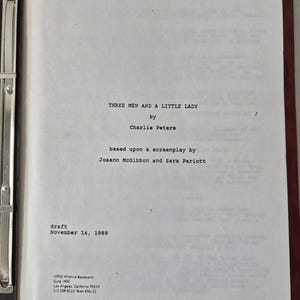 Op de afbeelding: Een wit titelblad van een scenario voor Three Men and a Little Lady door Charlie Peters, gebaseerd op een scenario van Josann McGibbon en Sara Pariott, gedateerd 14 november 1989, in een zwarte map met een zilveren metalen klem.