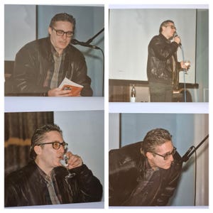 May include: Four-panel image of a man wearing glasses and a black leather jacket. He is either reading from a book, speaking into a microphone, or drinking from a glass. The background is a light blue wall.