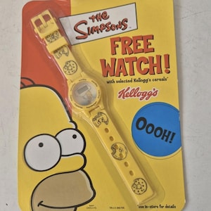May include: A yellow Simpsons watch on a yellow and red card. The watch has a digital display and a yellow strap with donut and character graphics. The card reads "FREE WATCH!" and features Homer Simpson.