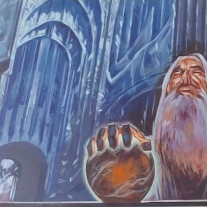 May include: A bearded man with a white robe holds a large, round, orange object in his hand. He is standing in front of a tall, blue, stone structure with intricate details.