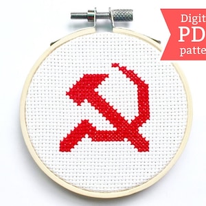 May include: A digital PDF cross-stitch pattern featuring a red hammer and sickle symbol on a white background.