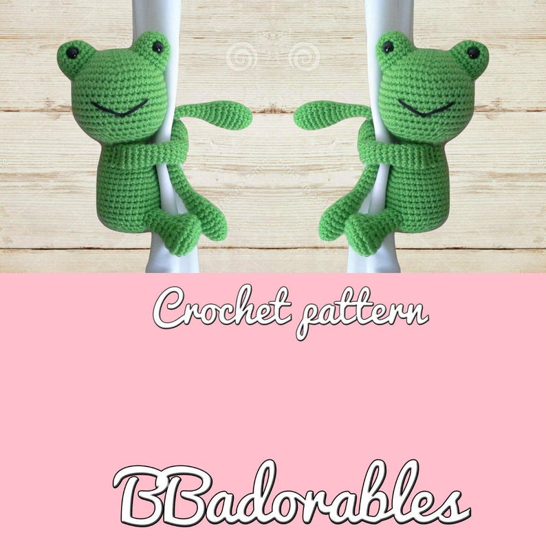 May include: Crochet pattern for a green frog amigurumi toy. The frog is holding onto a white pole with its arms and legs. The pattern is called "Badorables".