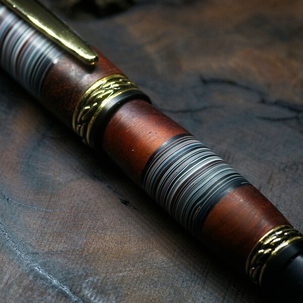 Satin segmented modern fordite and padauk rollerball pen