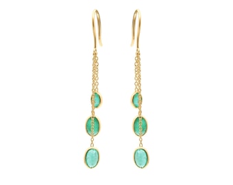 May include: Gold earrings with three green gemstone drops hanging from a chain.