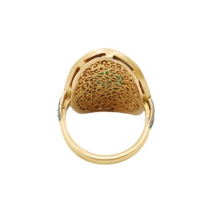 May include: A gold ring with a green stone set in a filigree design. The ring is set with small diamonds around the band.
