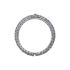 May include: A silver bangle bracelet with a row of light purple rectangular stones.