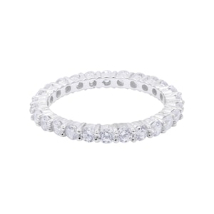 May include: A silver eternity band ring with a row of clear round cubic zirconia stones.