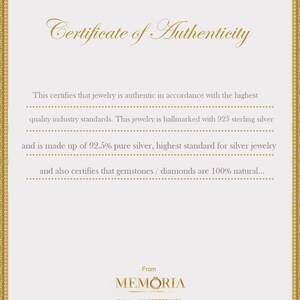 May include: Certificate of Authenticity for jewelry, stating it is made with 925 sterling silver and 92.5% pure silver. It also certifies that gemstones and diamonds are 100% natural. The certificate is from MEMORIA, with contact information for phone and email.