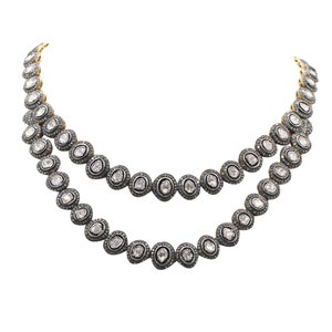 Close-up of Polki diamonds set in mixed metal gold and silver necklace, showing intricate craftsmanship