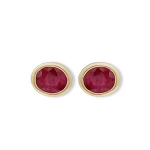 May include: A pair of gold stud earrings with red ruby gemstones.