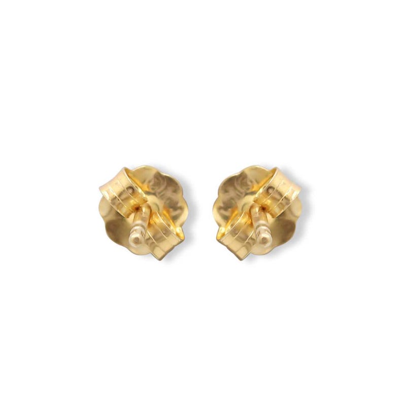 Back view of two gold stud earrings showing the butterfly scroll backs attached to the posts.