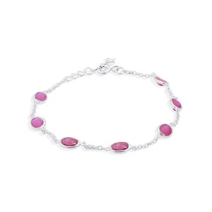 May include: A silver chain bracelet with pink oval-shaped gemstones.