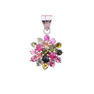 May include: A silver pendant featuring a cluster of colorful gemstones. The pendant showcases a variety of round-cut gemstones in shades of pink, green, yellow, and black, arranged in a floral pattern. The pendant has a silver bail for attaching to a chain.