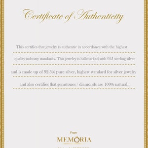 May include: Certificate of Authenticity for jewelry, stating it is made with 92.5% pure silver and 100% natural gemstones or diamonds. The certificate is from MEMORIA, with contact information for phone and email.