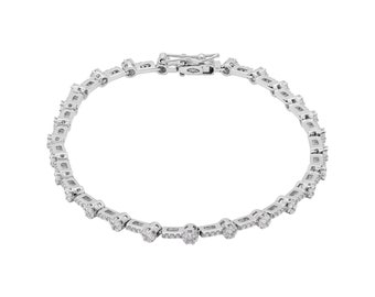 Op de afbeelding: Een zilveren tennisarmband met een rij kleine, ronde diamanten.