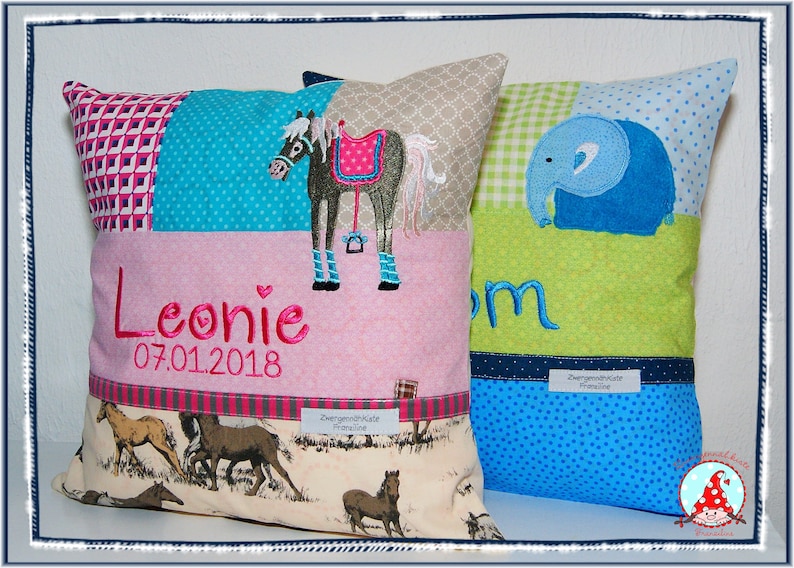 May include: Two personalized pillow covers with embroidered designs. One pillow features a horse with a pink saddle and the name Leonie with the date 07.01.2018. The other pillow features a blue elephant and the name Tom.