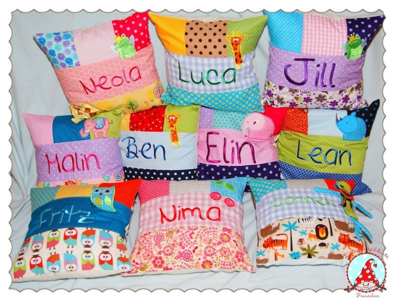 May include: Ten colorful patchwork pillow covers with different embroidered names, including Neda, Luca, Jill, Halin, Ben, Elin, Lean, Fritz, Nima, and Janne. Each pillow cover features a unique design with various fabrics and appliques.