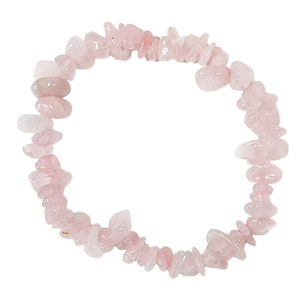 May include: A pink rose quartz chip bracelet made with natural stones. The bracelet is made with small, irregular shaped chips of rose quartz that are strung together on a clear elastic cord.