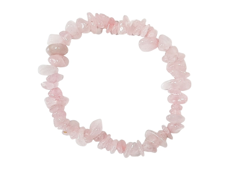 May include: A pink rose quartz chip bracelet made with natural stones. The bracelet is made with small, irregular shaped chips of rose quartz that are strung together on a clear elastic cord.