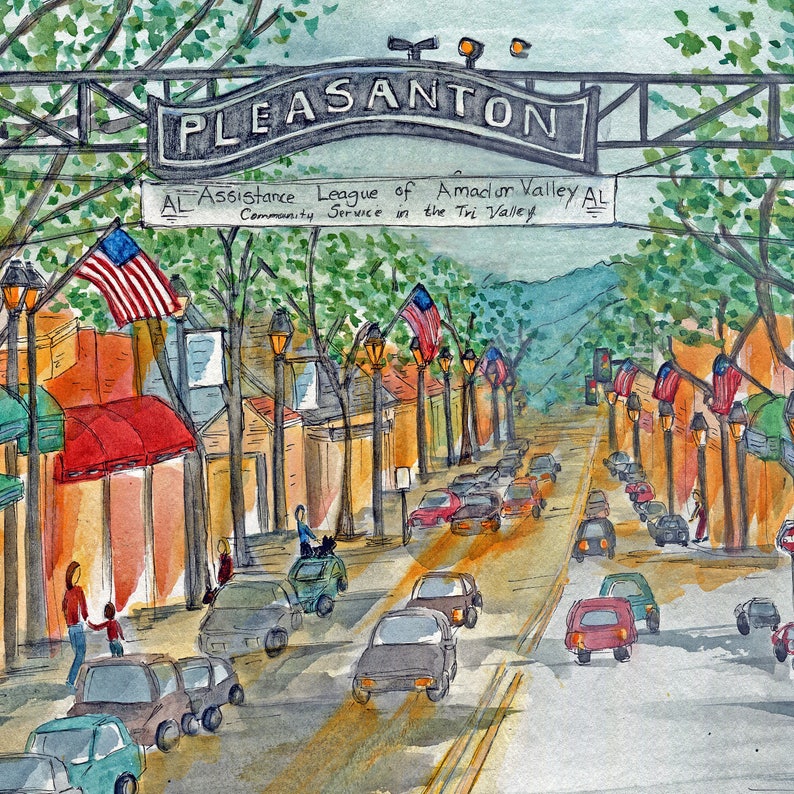May include: A watercolor painting of a street scene in Pleasanton, California. The street is lined with shops and buildings, and there are cars driving down the street. There are American flags hanging from the buildings, and a sign that reads "Assistance League of Amador Valley AL Community Service in the Tri Valley AL".