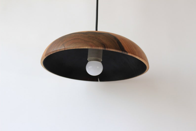 May include: A wooden pendant light with a black interior and a single light bulb.