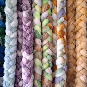 May include: A collection of colorful braided yarn strands, each with a unique pattern and color combination. The yarn is made of wool and is perfect for knitting or crocheting.