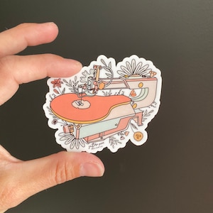 May include: A sticker featuring a pink and blue jigsaw with floral details. The sticker has the text "jigsaw piece design co" at the bottom.