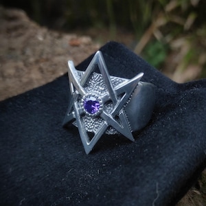 Thelemic symbol unicursal hexagram star ring , occult mysterious obscure religious artefact , ancient black metal gear , magic witch present