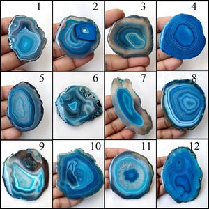 May include: Twelve agate slices with blue and white banding. The agate slices are arranged in a grid pattern. Each slice is numbered 1 through 12.