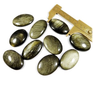 Sprankelende obsidiaan edelsteen. Obsidiaan met gouden glans. Natuurlijke gouden obsidiaan cabochon. Groothandelkavel 10 st ovale vorm obsidiaan 317 kt KB-11083
