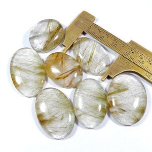 Multi gouden rutiel cabochon. Natuurlijke koperen rutielkwarts edelsteen. Ovale vorm groothandel kavel 7 stuks kristalrutiel voor sieraden 239 kt KB-11185