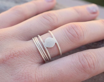 Set of 4 rings, a double sterling silver ring with circle and 3 stacking rings