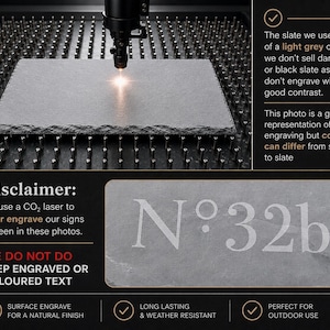 May include: A rectangular light grey slate sign featuring the laser-engraved text N&deg;32b. The image displays a CO2 laser engraving process on a slate surface with text disclaimers regarding the light grey color and surface engraving technique.
