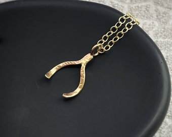 Solid 9ct gold lucky wishbone pendant, a handmade hammered and textured recycled gold fortune blessed charm gold bone on solid gold chain