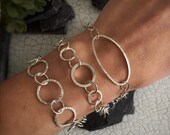 Hammered handmade sterling silver circle and oval link bracelets, inspired by trees and bark uniquely made by hand