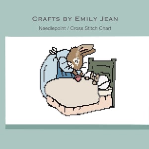 May include: A cross stitch chart featuring a pixelated illustration of a rabbit in bed, wearing a blue nightgown. The chart is labeled "Crafts by Emily Jean" and "Needlepoint / Cross Stitch Chart". The bed has a green headboard and a beige blanket.
