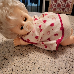 Blonde vintage crawling baby doll with pacifier