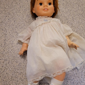 May include: A set of three ceramic mugs with a speckled, matte finish. The mugs are in shades of cream, light gray, and dark gray. Each mug has a simple, minimalist design and a rounded handle.