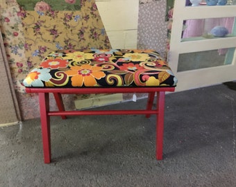 This is a vintage stool that I painted and recovered with floral retro looking fabric. This is a very comfortable and stylish stool.