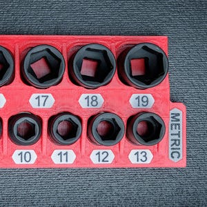 May include: A set of three ceramic mugs with a speckled, matte finish. The mugs are in shades of cream, light gray, and dark gray. Each mug has a simple, minimalist design and a rounded handle.