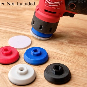 May include: Five sanding pads for a power sander. The pads are red, blue, white, and black. The sander is not included.  Sander Not Included.