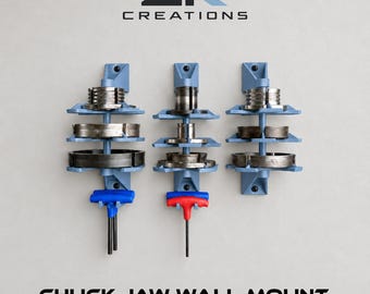 May include: Three light blue wall-mounted organizers for chuck jaws, each featuring three tiers for holding metal components. Two organizers include T-handle hex keys with blue and red handles. The text ZK CREATIONS and CHUCK JAW WALL MOUNT appear.